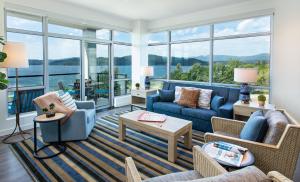 a living room with blue furniture and large windows at One Lakeside in Coeur d'Alene