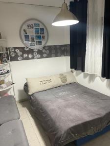 a bedroom with a bed with a pillow on it at אירוח על הים in Haifa