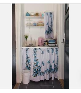 a kitchen with a table with curtains on it at Sundbyvestervarehus in Copenhagen