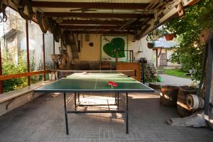 a ping pong table sitting inside of a garage at Kallaste Talu- Turismitalu & Holiday Resort in Padise