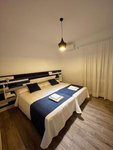 a bedroom with a large bed with two towels on it at Casa Rural VILLA KAIROS in Ajofrín