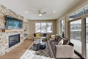 a living room with a fireplace and a tv at New Luxury Loft #307 With Huge Hot Tub & Great Views - 500 Dollars Of FREE Activities & Equipment Rentals Daily in Winter Park