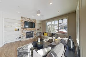 a living room with a couch and a fireplace at New Luxury Loft #307 With Huge Hot Tub & Great Views - 500 Dollars Of FREE Activities & Equipment Rentals Daily in Winter Park