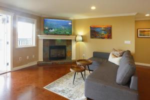 a living room with a couch and a fireplace at Lovely J Home -Stunning river view cozy two bedroom private suite in New Westminster