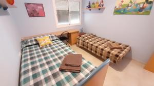 a room with two beds and a couch at El Vendrell montaña y playa in El Vendrell