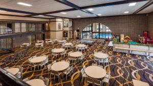 a large room with tables and chairs in it at Best Western Angus Inn in Great Bend