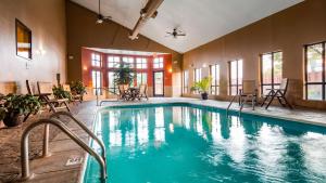 a pool in a room with chairs and tables at Best Western Plus Country Inn & Suites in Dodge City
