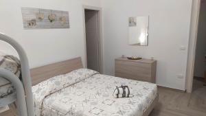 a small bedroom with a bed and a dresser at Cocciu d'amuri in Sciacca