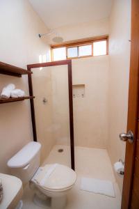 a bathroom with a toilet and a shower at Hotel Luna Roja Holbox in Holbox Island