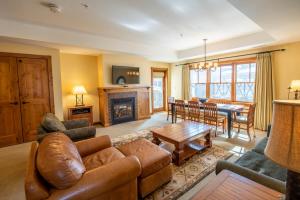 a living room with a couch and a table at Spacious 3 Bedroom Condo with Balcony in Mountaineer Square condo in Crested Butte