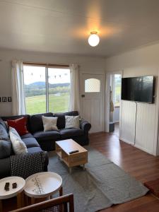 a living room with a couch and a table at Sassafras Springs in Ellendale