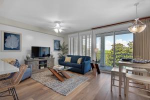 a living room with a blue couch and a table at The Grand Sandestin in Destin