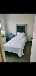 a bedroom with a white bed and a window at 2-bedroom apartment centrally located, near us consulate in Ciudad Juárez
