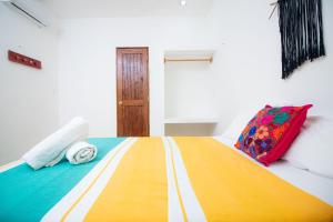 A bed or beds in a room at Posada Yalekin Holbox