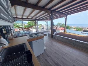 a large kitchen with a view of the ocean at la tête dans les nuages in Basse-Terre