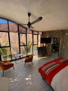 a bedroom with a bed and a ceiling fan at Cabañas Caballieri in Pisco Elqui +197 photos