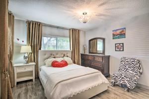 a bedroom with a bed and a dresser and a window at Shady and Eclectic Fort Lauderdale Dwelling with Yard! in Fort Lauderdale