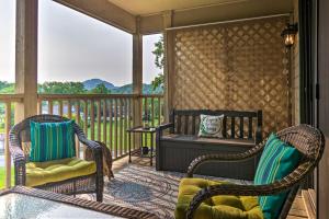 a screened in porch with two chairs and a bench at Modern Studio with Balcony about 1 Mi to Lake Lure! in Lake Lure