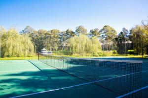 a tennis court with a tennis racket on it at Lincoln Downs Resort Batemans Bay, BW Signature Collection in Batemans Bay