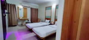 En eller flere senge i et værelse på Hotel Easy Retreat