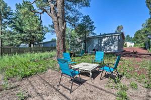 a table and chairs in front of a tree at Bright and Modern Flagstaff Cottage Escape! in Mountainaire