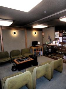 a living room with couches and a table and a tv at Murataya in Kanazawa