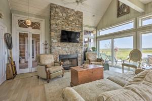 a living room with a couch and a fireplace at Spacious and Secluded Stilt Home on Fontaine Reserve in Ocean Springs