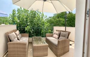 a patio with two chairs and a table and an umbrella at Summer Apartment in Makarska