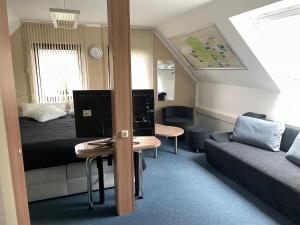 a bedroom with a bed and a desk with a computer at Ferienwohnung Geyer in Gräfenhainichen