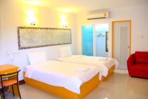 מיטה או מיטות בחדר ב-The Cottage Lampang