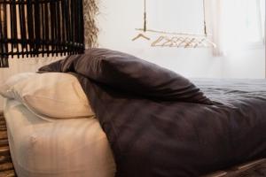 a blanket laying on top of a bed at Laguna Suite B&B in Chioggia