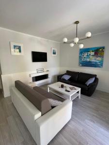 a living room with a couch and a table at The Tides in Sestri Levante