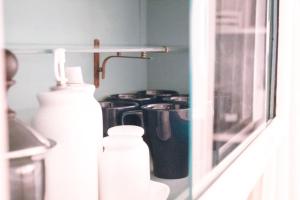 a shelf with bottles and a window in a room at Laguna Suite B&B in Chioggia