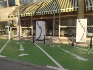 a green floor in front of a building at Hotel Albufera in Alfafar