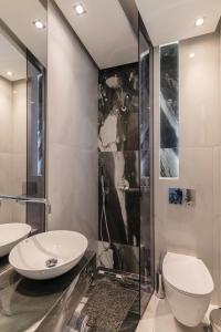 a bathroom with two sinks and a shower at Studios Filipidis in Chrysi Ammoudia