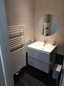 Favoriten-Rooms في فيينا: حمام مع حوض أبيض ومرآة