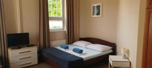 a small bedroom with a bed and a window at Hungarian Farmhouse in Zákányszék