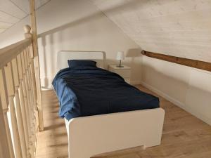a bedroom with a bed with a blue blanket at Les Récollets in Huy