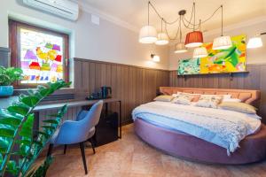 a bedroom with a large bed with a desk and a chair at Apartamenty u Sarzyńskich in Kazimierz Dolny