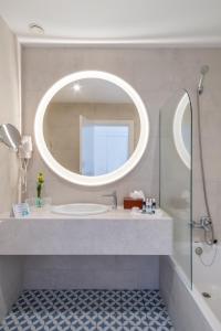 a bathroom with a sink and a mirror at Aqua Natura Bay in Porto Moniz