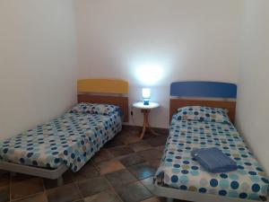 Postel nebo postele na pokoji v ubytování Casa vacanze nel verde del Sinis