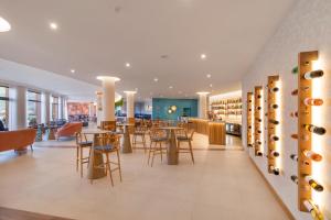 a restaurant with tables and chairs and wine racks at Aqua Natura Bay in Porto Moniz