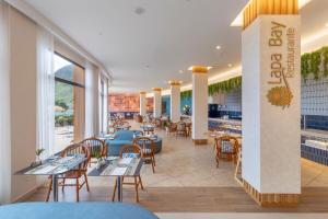 a restaurant with tables and chairs and a bar at Aqua Natura Bay in Porto Moniz