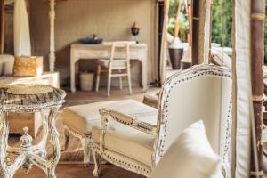a living room with white furniture and a table at Khwan Beach Resort - Luxury Glamping and Pool Villas Samui - Adults Only - SHA Extra Plus in Mae Nam