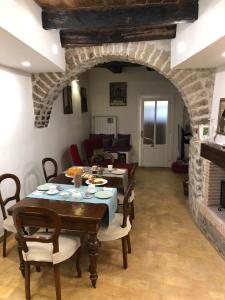 a living room with two tables and a fireplace at B&B Le Principesse in Sermoneta +55 photos