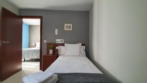 A bed or beds in a room at Hotel Les 7 Claus