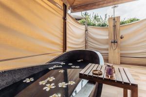 a room with a table and a tent at Khwan Beach Resort - Luxury Glamping and Pool Villas Samui - Adults Only - SHA Extra Plus in Mae Nam