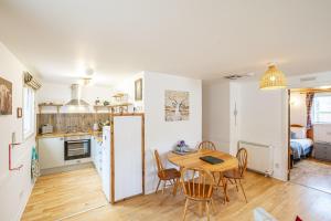a kitchen and dining room with a table and chairs at Heather Lodge 4, sleeping 6 in Belladrum +18 photos