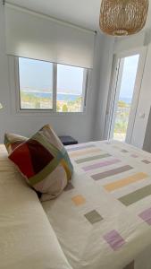 a bedroom with a large bed with a view of the ocean at El Faro de Torre del Mar in Torre del Mar