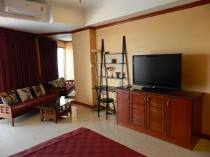 a living room with a flat screen tv on a cabinet at Studio View talay 2A in Jomtien Beach